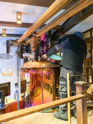 Working on the copper-colored brewing kettle